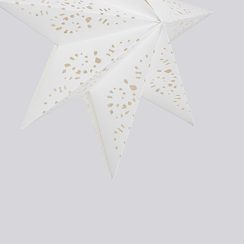 La pantalla en forma de estrella con intrincados recortes, elaborada con cartón de calidad y accesorios metálicos, emite una luz cálida.
