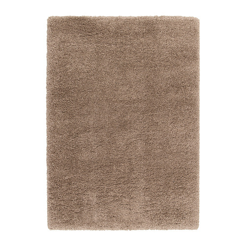 Una alfombra beige desgreñada de VOLLERSLEV con diferentes grosores de hilo, que ofrece una textura suave y propiedades insonorizantes.