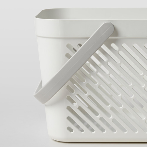 Cesta de almacenamiento de plástico blanco con agujeros, asa plegable para facilitar su transporte, perfecta para el baño o la cocina.