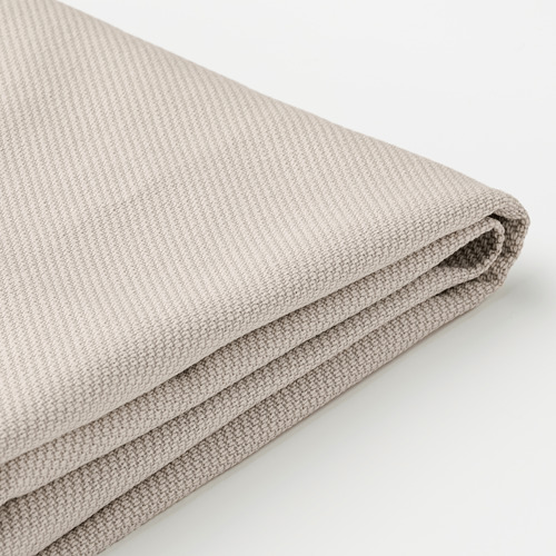 Tela beige doblada; suave, texturizado; Probablemente de alta calidad, lavable.
