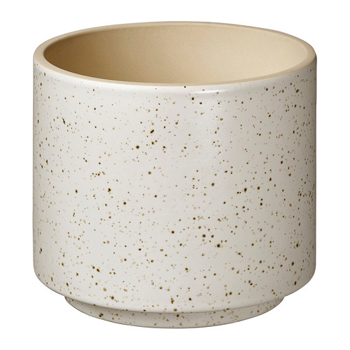 Jardinera cilíndrica beige con motas sutiles, acabado mate, diseño moderno y sencillo.