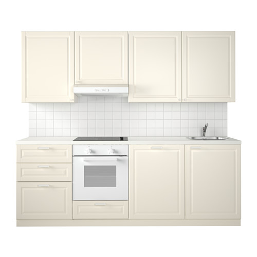 Configuración minimalista de cocina blanca con gabinetes color crema, fregadero y horno. Diseño luminoso y moderno, ideal para espacios reducidos.
