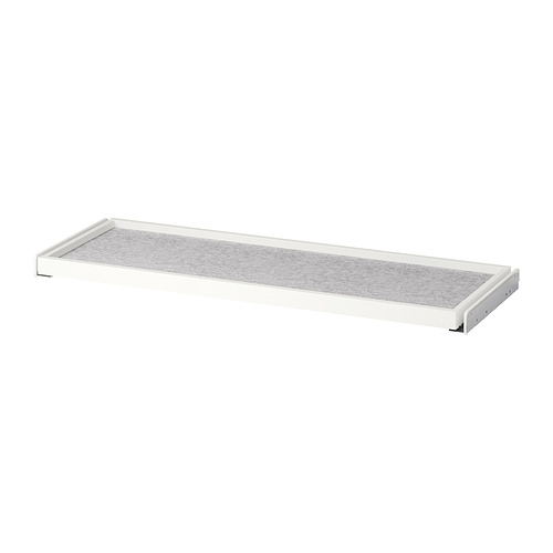 Un estante extraíble blanco de KOMPLEMENT en un armario, con una alfombrilla de fieltro gris. Diseño rectangular y minimalista para organizar el espacio.
