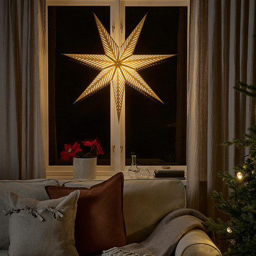Ventana exterior de luz de estrella dorada, noche brillante, flor de Pascua roja, sofá acogedor.