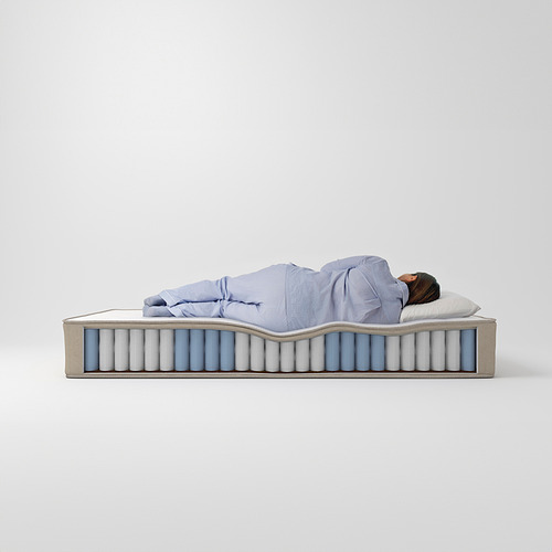 Una mujer duerme en un colchón de color gris azulado, ondulado y plano con muelles ensacados visibles.