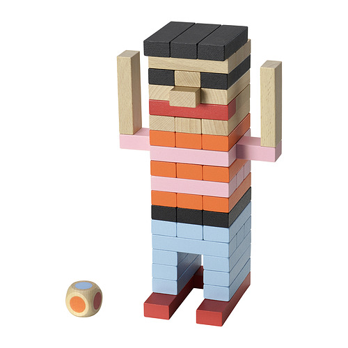Figura de bloques de construcción Fjällrävak en multicolor. Los bloques son cuadrados y se apilan para formar una forma humanoide con un dado cerca.