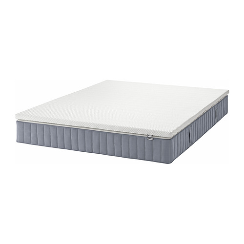 Representa un colchón de muelles ensacados VALEVÅG gris, diseñado para personas que duermen de forma media a pesada, con 5 zonas de confort y bordes transpirables.