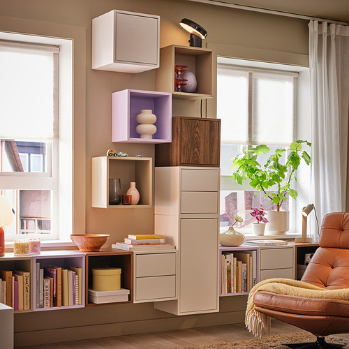 Unidad de almacenamiento EKET blanca y morada junto a la ventana y la silla.