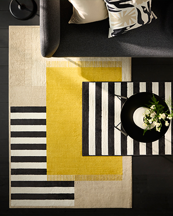 Modern IKEA living room with sofa, coffee table, and geometric rug. Decor ideas and style for your lounge.