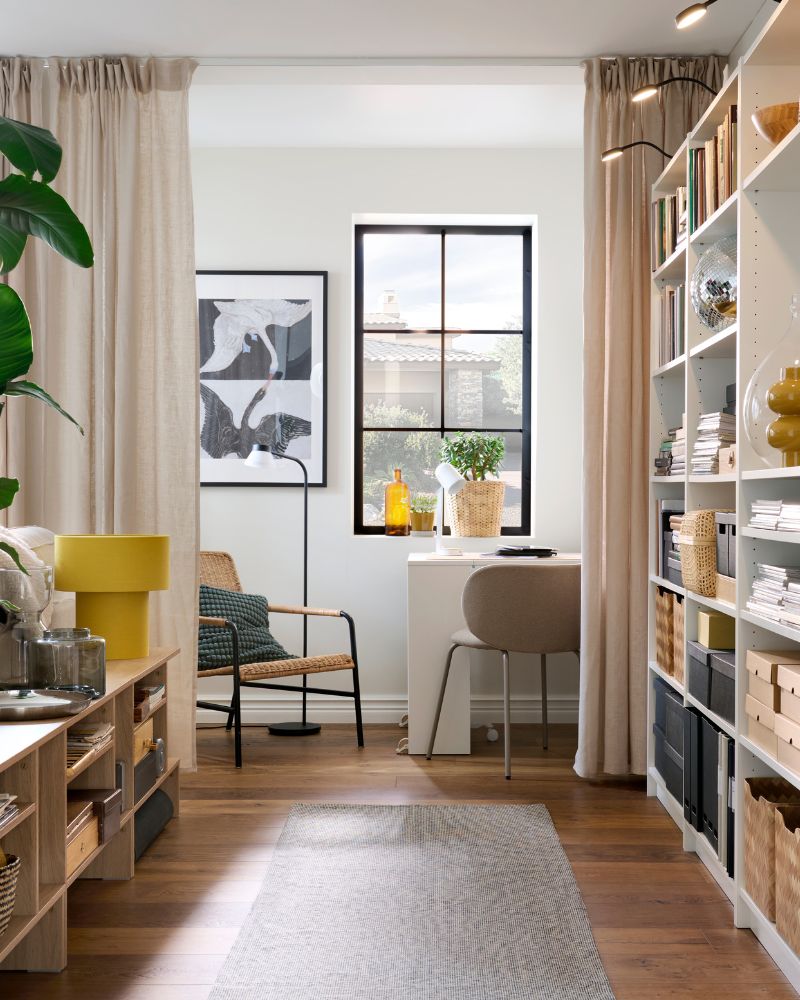 Part of a bright living room framed by  HOLMERUD side tables and BILLY bookcases  fitted with YTBERG LED cabinet lighting.