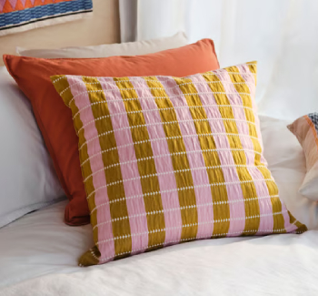 two colorful cushions, one behind the other, in autumn colors.