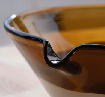 Detail of a large dark glass bowl.