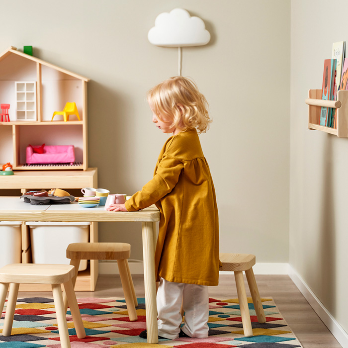 una niña jugando en su mesa infantil
