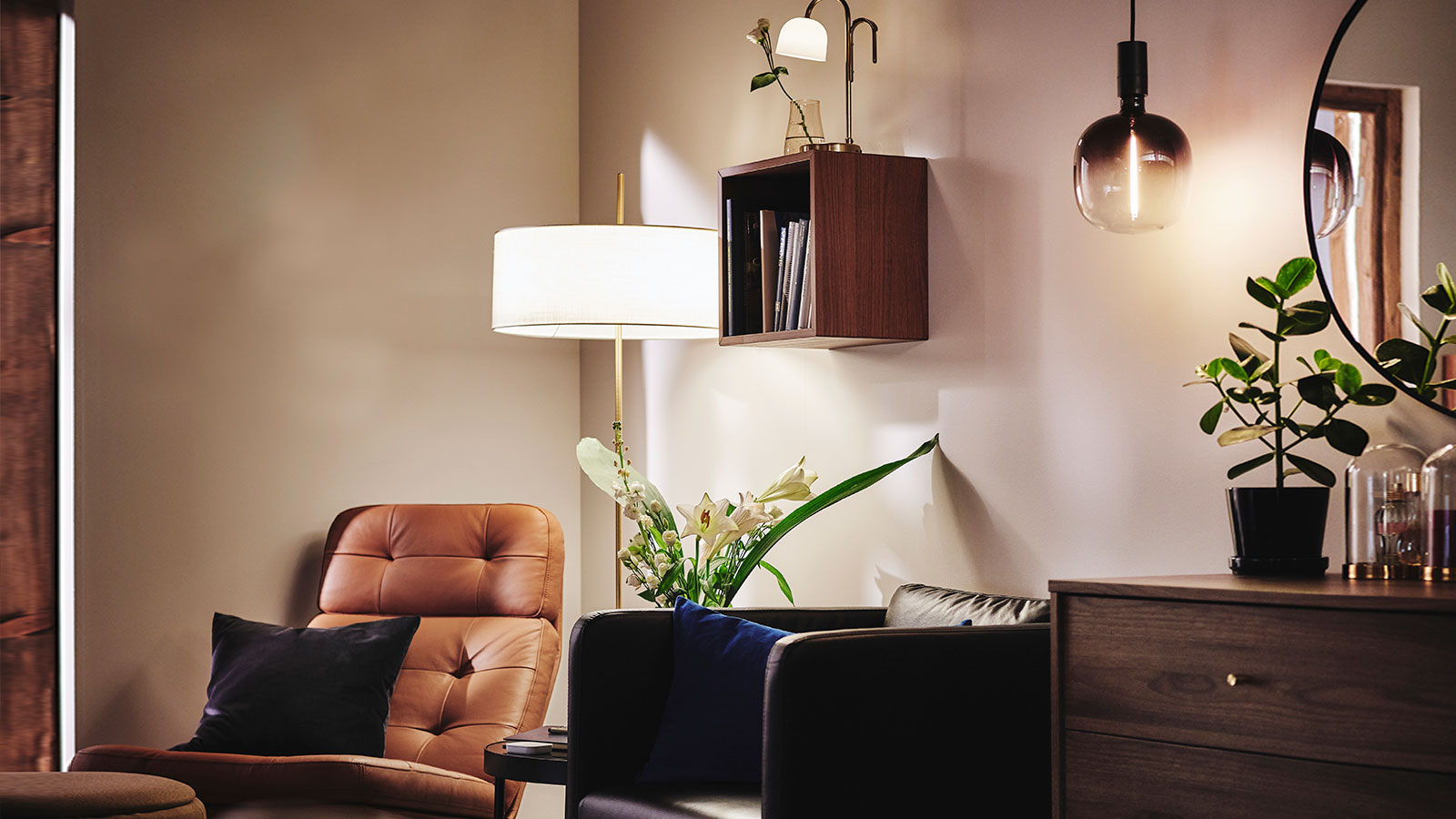 Relaxing corner in a bedroom, with two armchairs and different light sources such as STOCKHOLM 2025 floor lamp.
