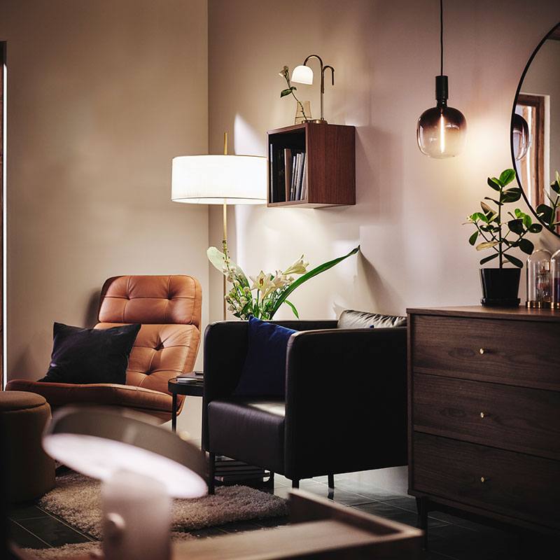Relaxing corner in a bedroom, with two armchairs and different light sources such as STOCKHOLM 2025 floor lamp.