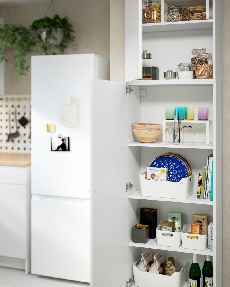 The kitchen has two white KNOXHULT wall cabinets, with UPPDATERA boxes and KORKEN containers inside.