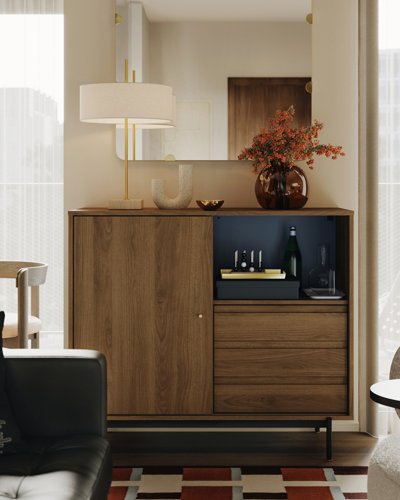 A STOCKHOLM 2025 table lamp and a STOCKHOLM 2025 vase stand on top of a RÅDMANSJÖ cabinet in an Instagram worthy living room.