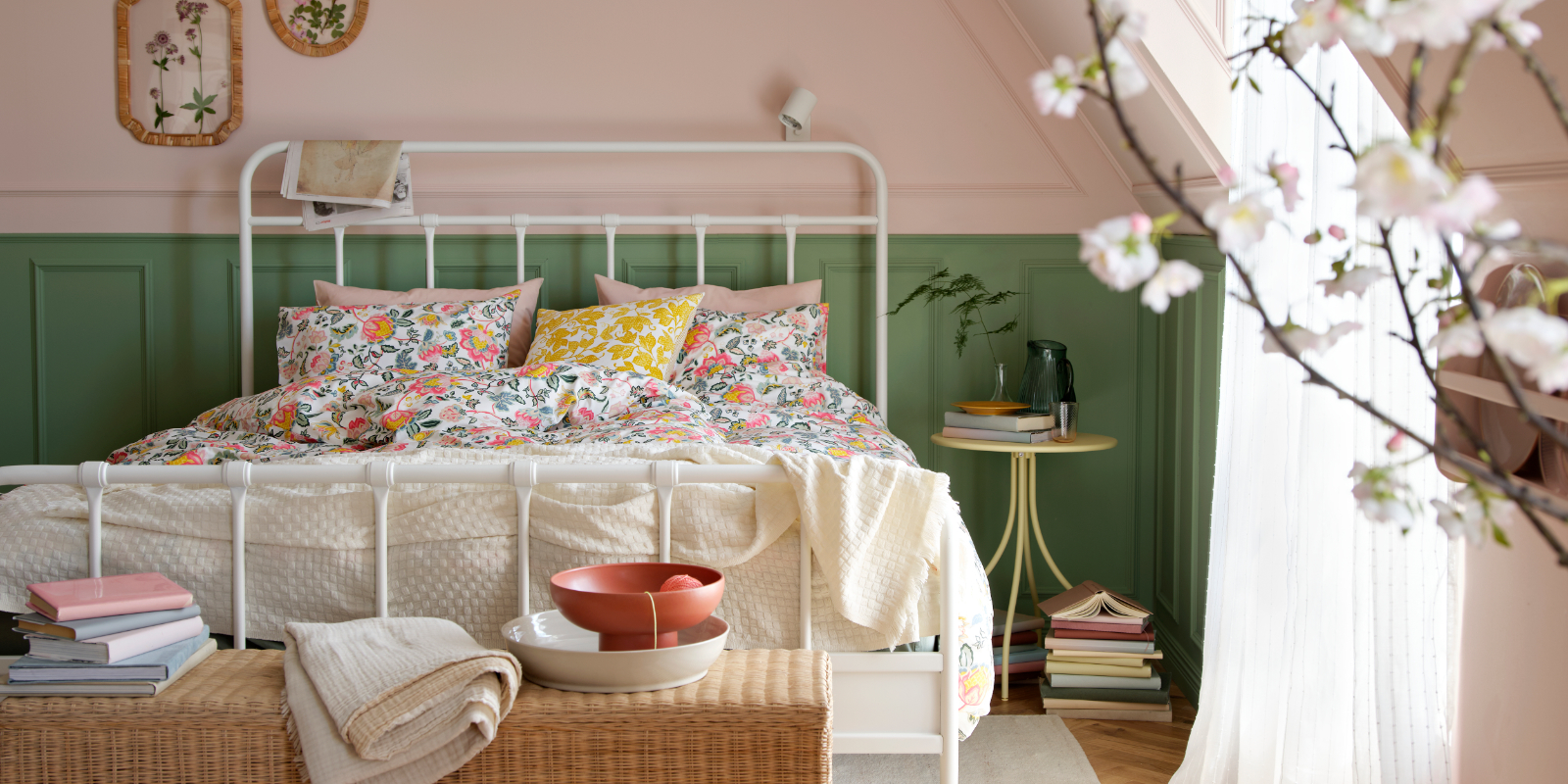 A bright bedroom featuring a white STJÄRNÖ bed frame adorned with a colourful DAGGSALVIA duvet cover and pillowcase set.