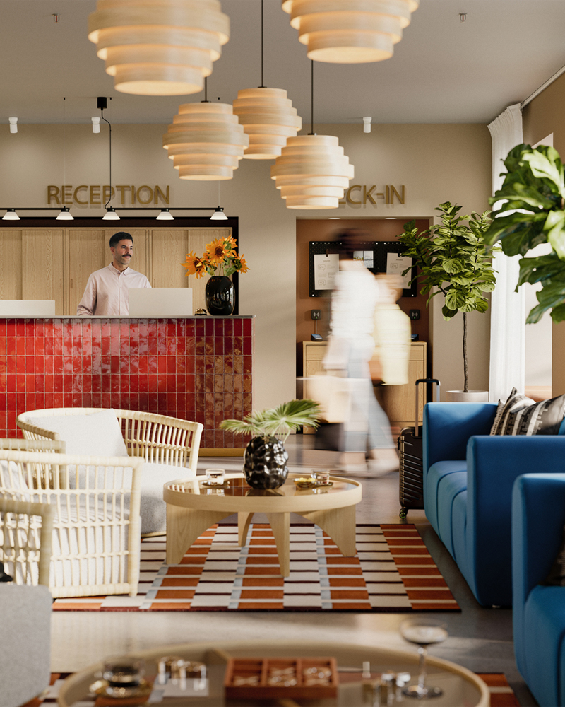Hotel lobby scene with a grey/white STOCKHOLM 2025 rattan armchair, a sofa, coffee table, and two people sitting and talking.
