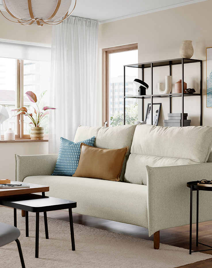 Living room corner with a sofa, cushions, and a coffee table.