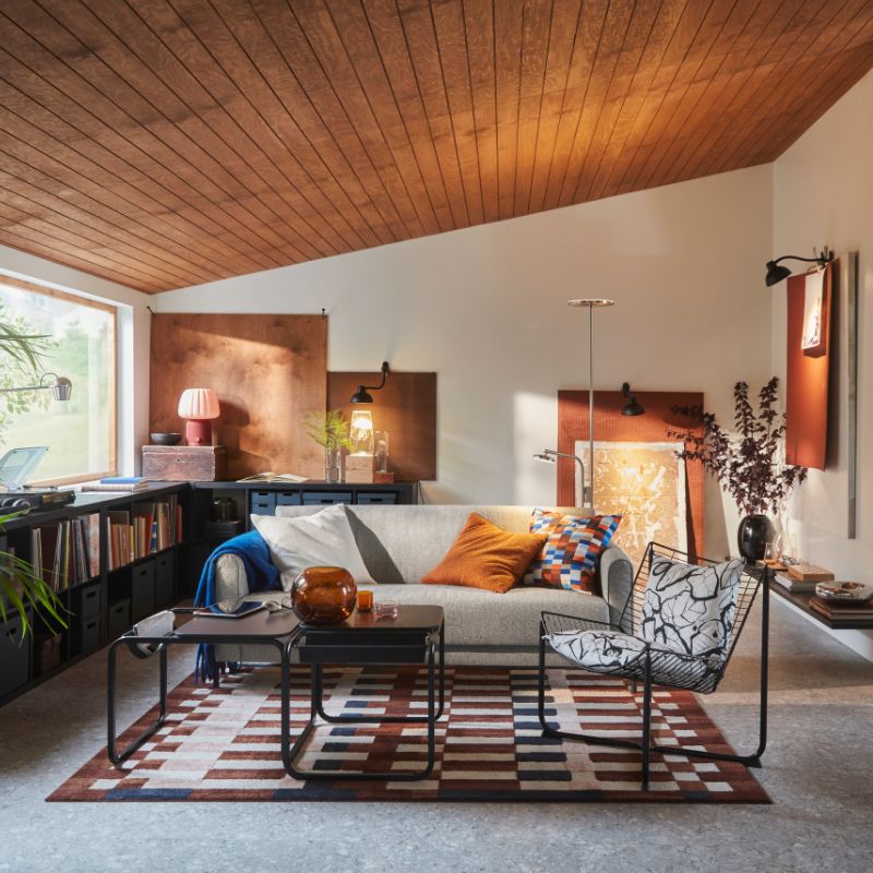 A living room features an Öreryd grey-beige SALTMYRAN 3- seat sofa placed in front of a coffee table and on a MARKBLÅMME rug.