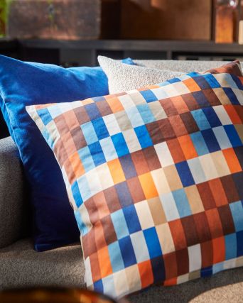 Primer plano de un sofá de 3 plazas SALTMYRAN con una funda de cojín LÖVNATURSKOG marrón/azul y otros dos cojines.