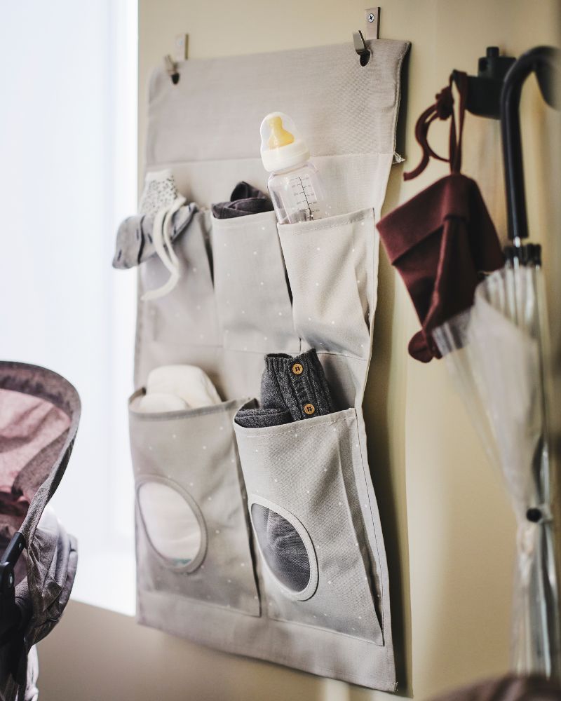 Practical hanging storage featuring the LEN organizer with spacious pockets, supported by BLECKA hooks.