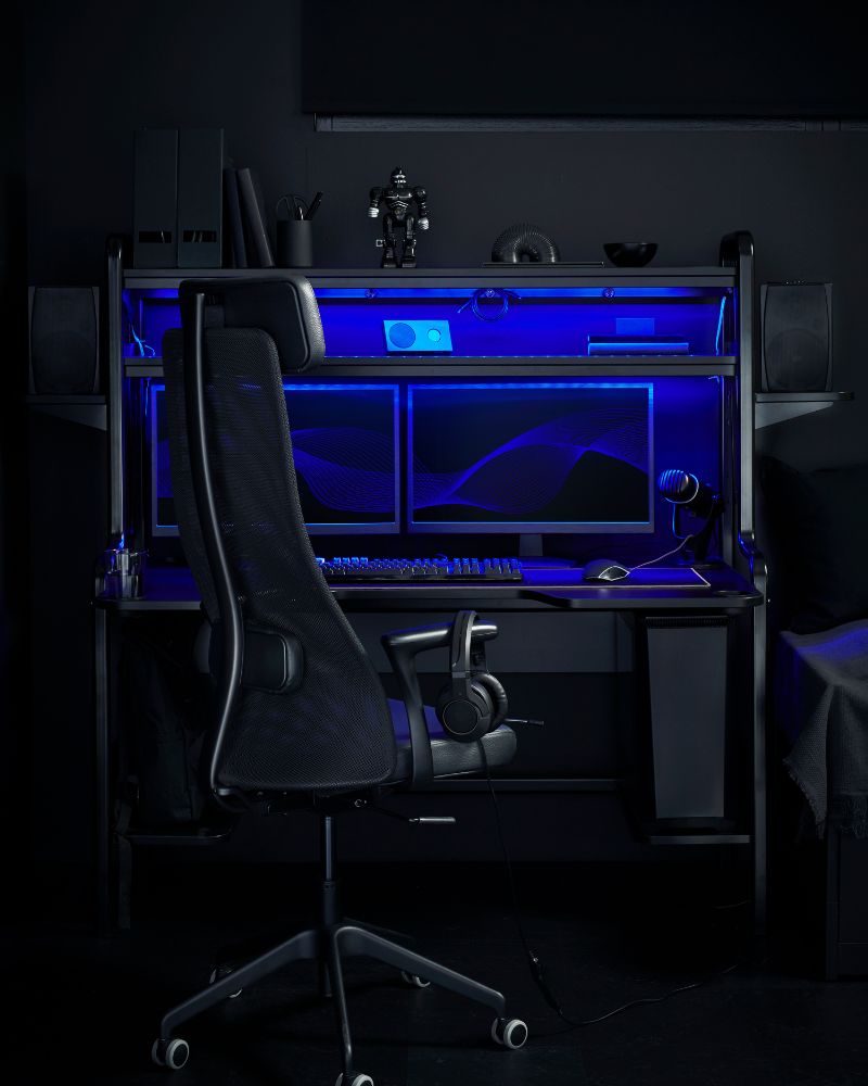 Gaming room: UPPSPEL desk, blue LEDs, MATCHSPEL Gaming chair, dual monitors.
