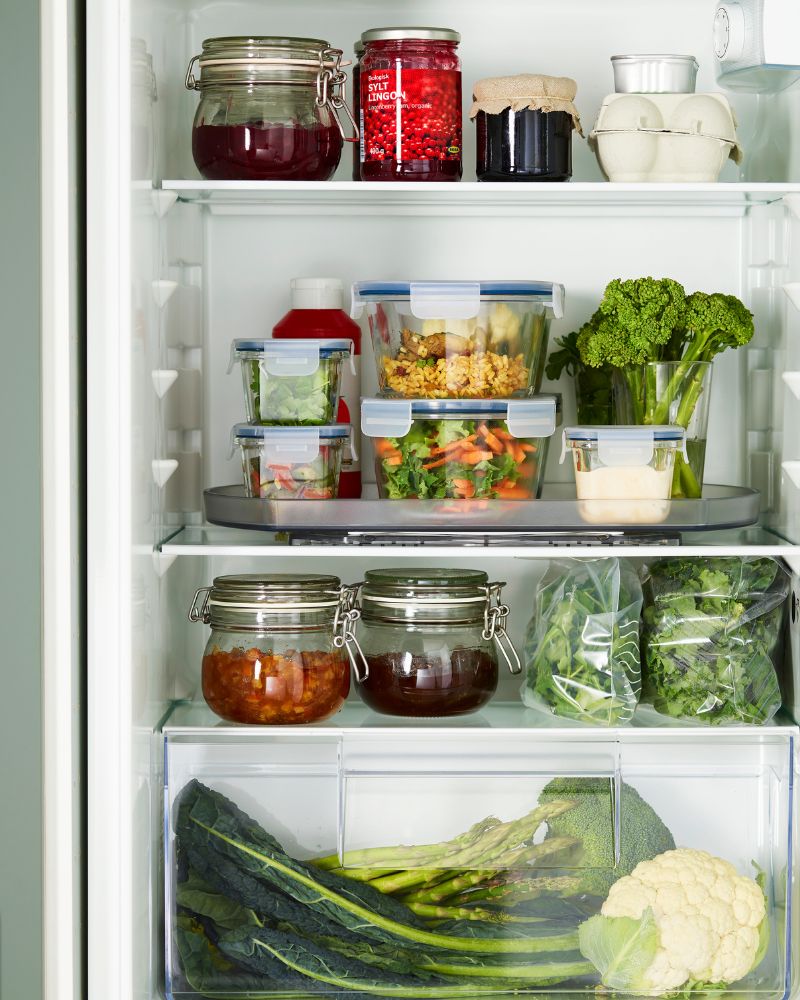 Organized fridge with IKEA 365+, KORKEN and SNURRAD turntables for clear, easy‑to‑reach food storage.