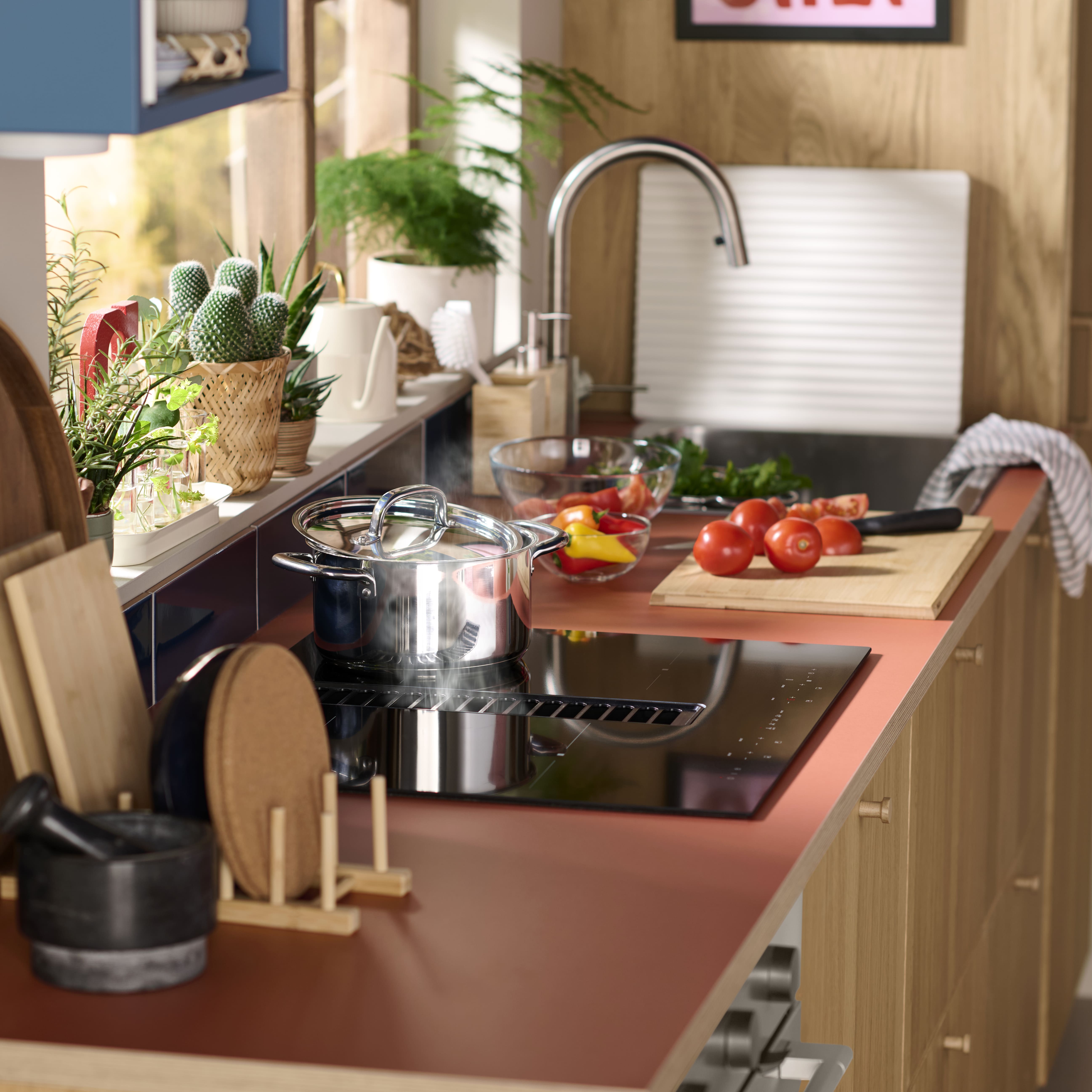 Close-up of a person placing a plate into a terracotta pink cabinet with ribbed texture and integrated LED lighting.