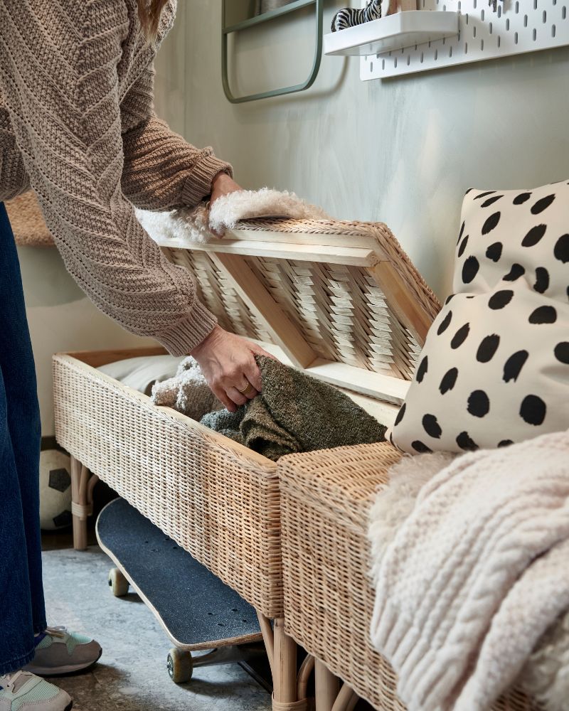 Functional entryway with TOLKNING storage bench, TOFTLUND rug, SKÅDIS pegboard, SPARKA soft toys and ODDNY cushion cover.