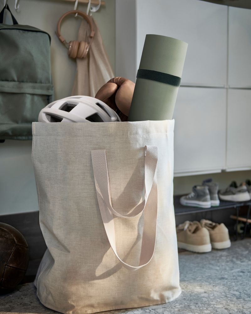 Practical entryway corner with PURRPINGLA laundry bags, GREJIG shoe rack and TRONES shoe storage.