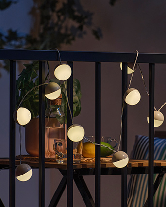 SOLVINDEN LED string lights illuminating a railing.