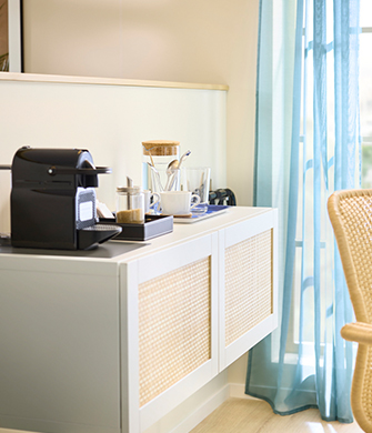 Two-door cabinet with a coffee maker on top