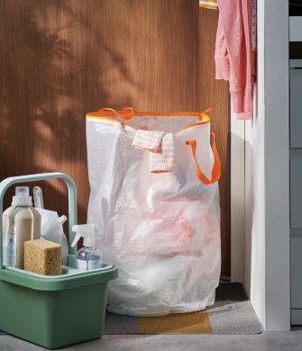 Functional storage space with PÄRKLA laundry bag, PEPPRIG cleaning bucket with trolley and STORKLINTA chest of drawers.